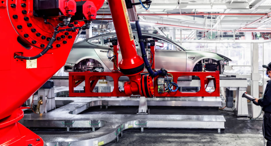 Tesla Robotic Arm (AI-powered) in action at a Tesla Gigafactory (Image: Tesla)